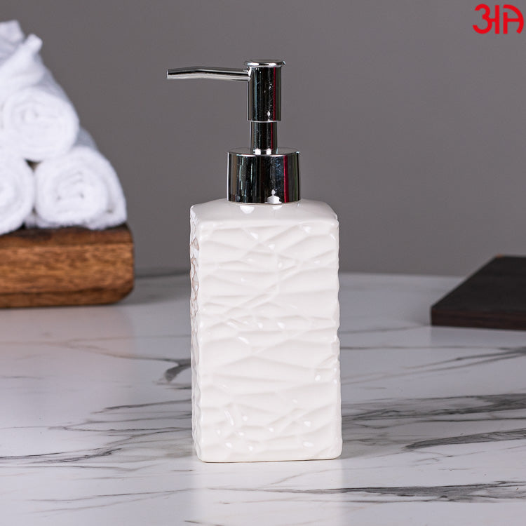 white ceramic soap dispenser with pump