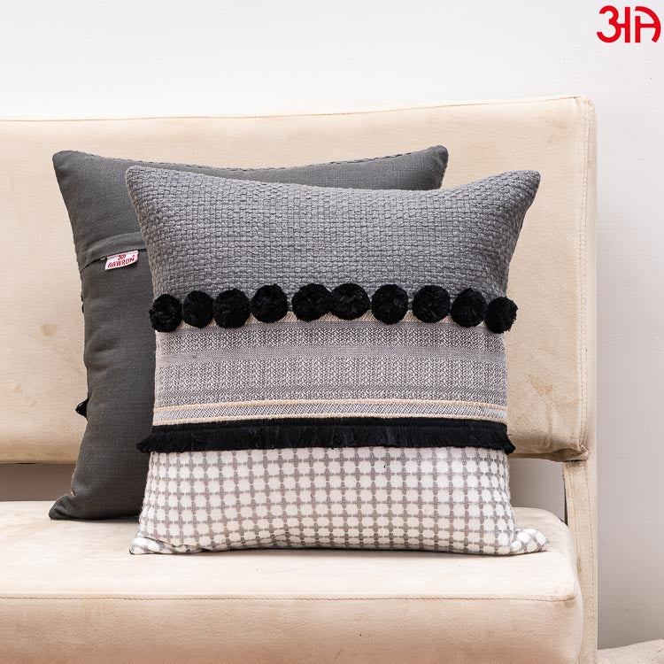 black pompom cushion