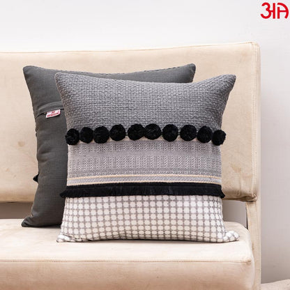 black pompom cushion